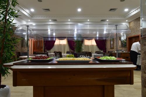 a buffet with several plates of food on a table at Hôtel Fès Inn & SPA in Fès