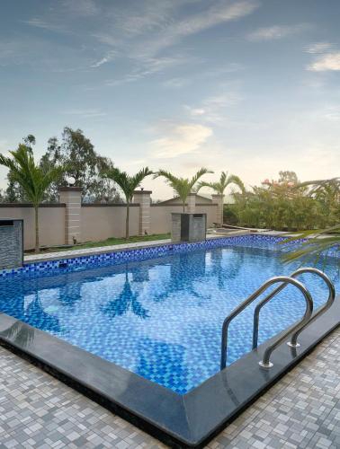 a large swimming pool with blue water at Blizzard Resort in Panchgani