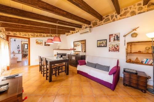 a living room with a couch and a table at Ca Sa Padrineta in Capdepera