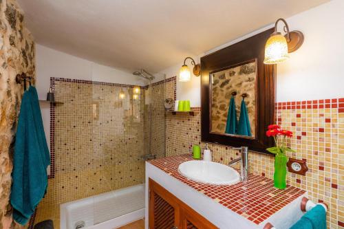 a bathroom with a sink and a shower and a tub at Ca Sa Padrineta in Capdepera