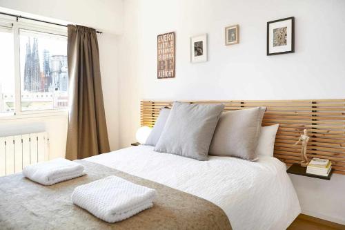 a bedroom with a large bed with two pillows on it at SAGRADA FAMILIA VIEWS Nos preocupa su seguridad in Barcelona