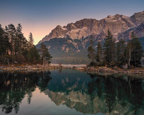 a view of a lake with mountains in the background at Das Bergquartier - Ferienwohnung Krottenkopf in Oberau
