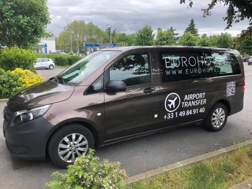 a small black van parked in a parking lot at Euro Hôtel Airport Orly Rungis in Fresnes