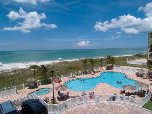 a view of a swimming pool and the beach at Sunset Vistas Two Bedroom Beachfront Suites in St Pete Beach