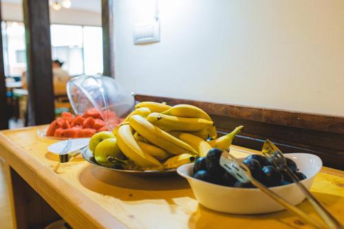 a bowl of bananas and other fruit on a table at Hotel Class in Brezoi