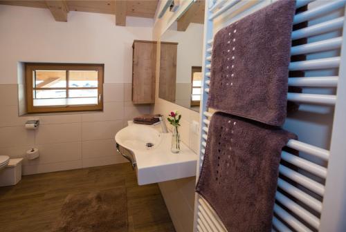 a bathroom with a sink and a mirror at Appartemets Hauserbauer in Kaprun