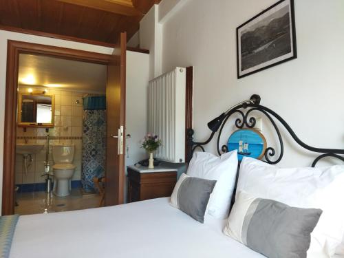 a bedroom with a bed and a bathroom at Hotel PARALIAKO Kyparissi in Kyparíssion