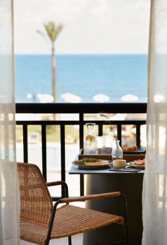 a table with a tray of food on a balcony at Asterion Suites & Spa - Designed for Adults in Gerani Chanion