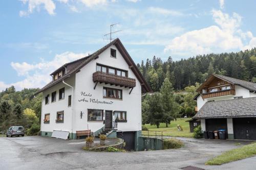 a white building with a sign on the side of it at Am Wehrastrand App 2 in Todtmoos