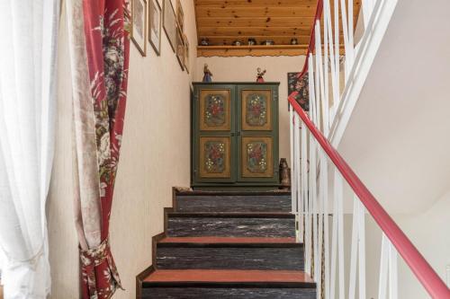 a staircase with a green door in a house at Am Wehrastrand App 2 in Todtmoos