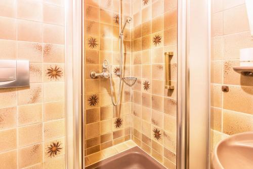 a bathroom with a shower with a sink at Am Wehrastrand Einzelappartment in Todtmoos