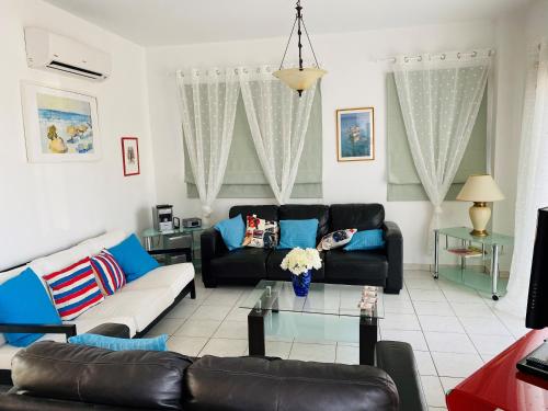 a living room with a couch and a table at Villa Emiliana in Paralimni