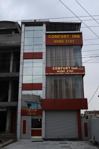 a building with a sign that reads comfort inn home stay at Hotel Comfort Inn Homestay in Dehradun