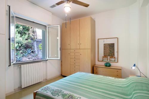 Schlafzimmer mit einem Bett und einem Fenster in der Unterkunft Casa Laigueglia in Laigueglia