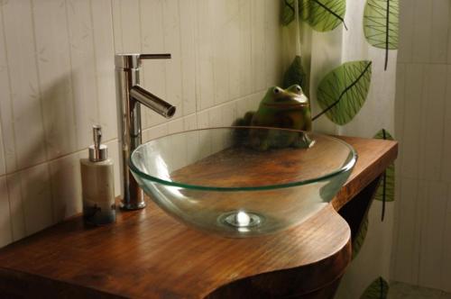 un cuenco de cristal en un lavabo de madera en el baño en agata, en Punta del Diablo