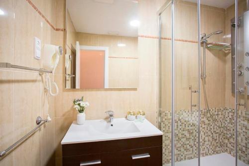 y baño con lavabo y ducha. en H-A San Mateo Suites, en Madrid