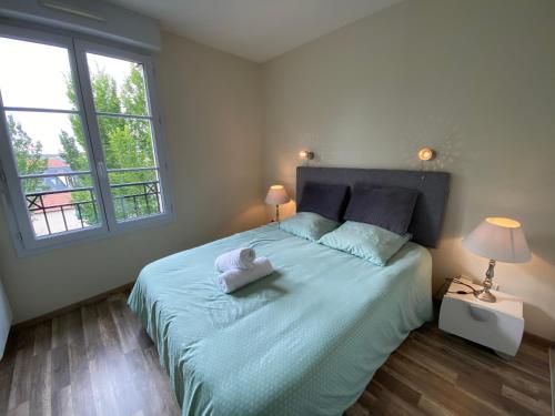 Postel nebo postele na pokoji v ubytování T2 Disney Paris/Val d'europe