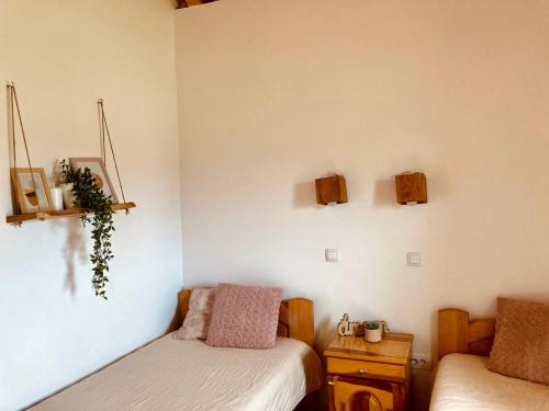 a room with two beds and a table with a bedskirts at Planinska Koliba Exclusive in Sekulić 