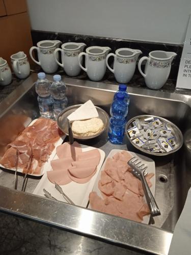 a kitchen counter with plates of food and drinks at HOTEL DUCA D'AOSTA in Mogliano Veneto