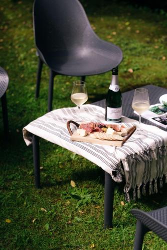 a table with a bottle of wine and two glasses at Hotel Cashiers in Cashiers