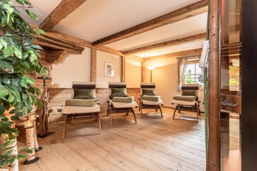 a group of chairs in a room with wooden floors at Wellnessappartements Margit in Alpbach