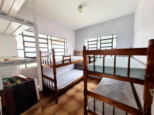 Ένα ή περισσότερα κρεβάτια σε δωμάτιο στο Ohana Casa Boraceia