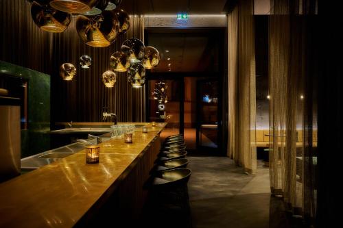 a bar with a row of bar stools at Villa Boutique Hotel in Straubing
