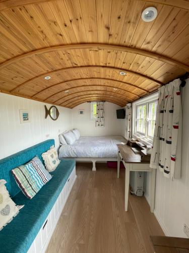 a room with a couch and a bed in a tiny house at Mount View Overnight Accommodation in Penzance
