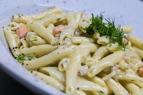 a bowl of pasta with parsley on top of it at ViP Chalet 4 Seasons in Arachova