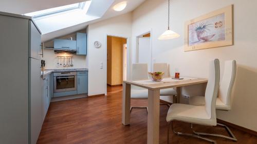 a kitchen and dining room with a table and chairs at Sonnenhof Hagnau in Hagnau