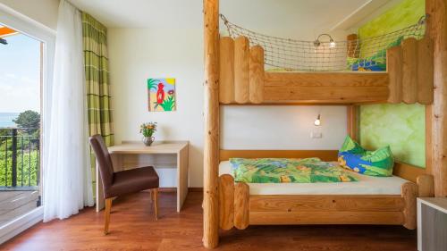a bedroom with a bunk bed and a desk at Sonnenhof Hagnau in Hagnau