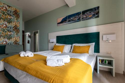 a bedroom with a large bed with towels on it at Hotel Limone in Limone sul Garda