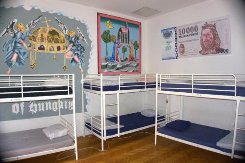 two bunk beds in a room with a mural at Vitae Hostel in Budapest