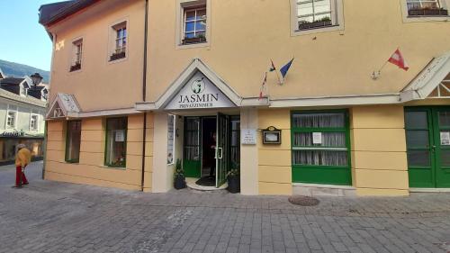 a building with a person standing outside of it at Jasmin dog friendly pension with shared kitchen in the center in Murau