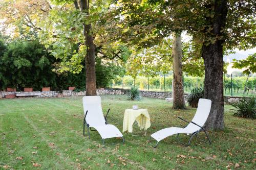 two chairs and a table in a park at Villa Guarienti Valpolicella in Fumane