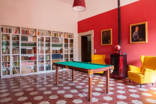 a room with a ping pong table and bookshelves at Villa Guarienti Valpolicella in Fumane