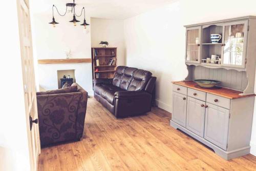 a living room with a couch and a chair at 3-Bed Cottage-Plymouth-Dog friendly-Sleeps7 in Plymouth