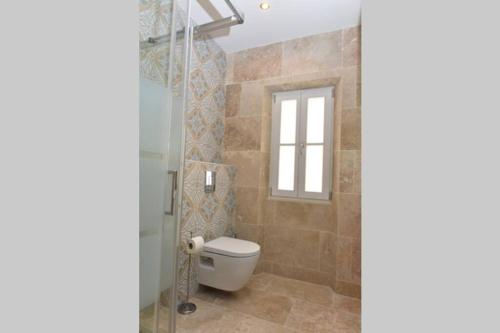 a bathroom with a toilet and a window at PICASSO by the sea Luxurious design house sea view old Antibes for 6 in Antibes