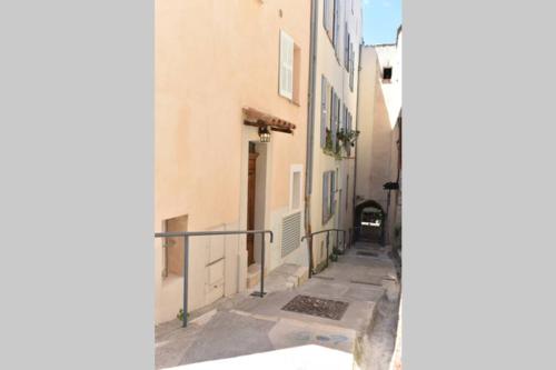 a narrow alley with a building and a gate at PICASSO by the sea Luxurious design house sea view old Antibes for 6 in Antibes