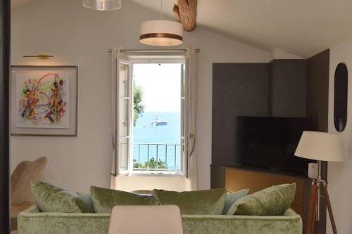 a living room with a couch and a window at PICASSO by the sea Luxurious design house sea view old Antibes for 6 in Antibes