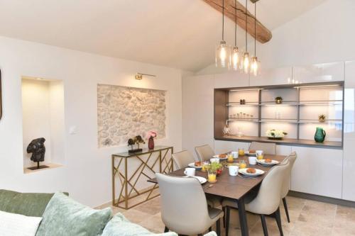 a dining room and living room with a table and chairs at PICASSO by the sea Luxurious design house sea view old Antibes for 6 in Antibes