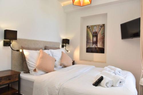 a bedroom with a white bed with towels on it at PICASSO by the sea Luxurious design house sea view old Antibes for 6 in Antibes