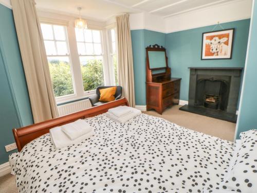 1 dormitorio azul con 1 cama y chimenea en Hope Cottage South, en Richmond
