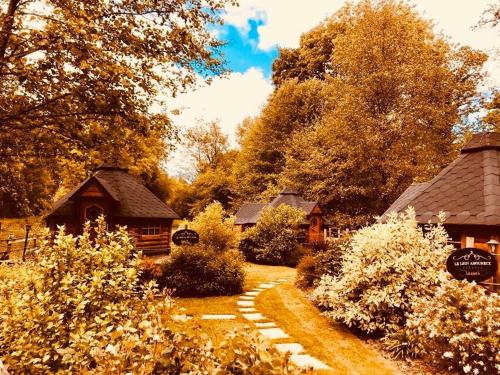 a garden with a path leading to a cabin at Les Roulottes De La Basse Maunerie in Les Herbiers