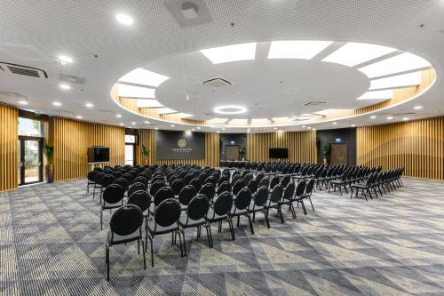a conference room with chairs and a stage in the middle at Grand Hotel Esztergom in Esztergom