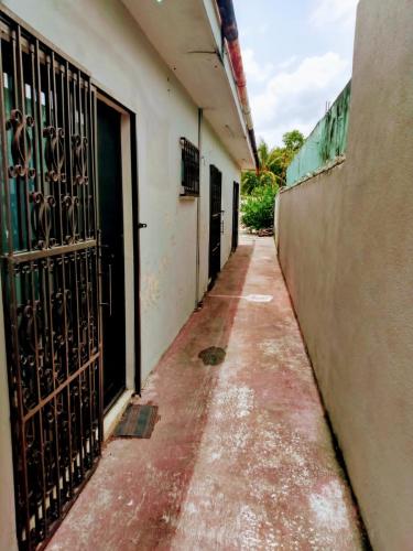 an empty alley with a gate in a building at Casa Ixchel - 700m to Downtown, WiFi, Hot Water, AC in Valladolid