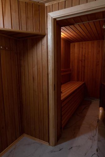 a small sauna with a wood paneled wall at NOMAD APARTMENTS in Mažeikiai