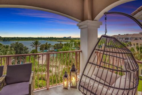a balcony with a hammock and a view of a lake at Top floor condo with view of lake, pool and fireworks! Next to Convention Center! in Orlando