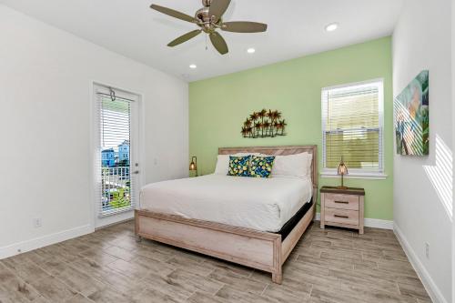 a bedroom with a bed and a ceiling fan at Margaritaville Cottage, PRIVATE POOL, Near Disney in Orlando