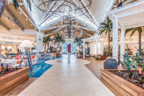 a lobby with palm trees and a chandelier at Margaritaville Cottage, PRIVATE POOL, Near Disney in Orlando